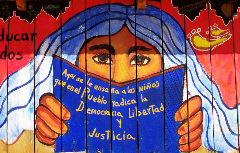 School mural of Zapatista blue haired woman in Chiapas, Mexico.