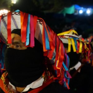 Wearing traditional Tzotzil hats and carrying poles of power, Zapatista authorities listen intently to presentations by the families of the the 43 disappeared student-teachers from Ayotzinapa on Jan. 31, 2014.