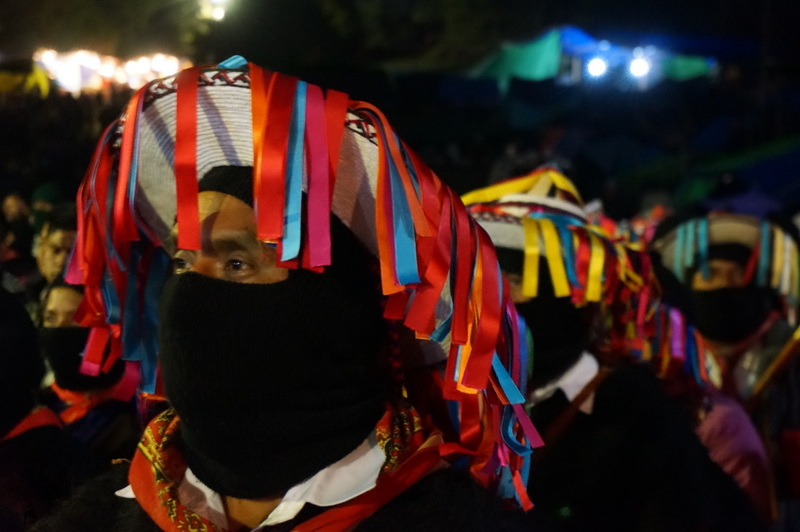 Wearing traditional Tzotzil hats and carrying poles of power, Zapatista authorities listen intently to presentations by the families of the the 43 disappeared student-teachers from Ayotzinapa on Jan. 31, 2014.