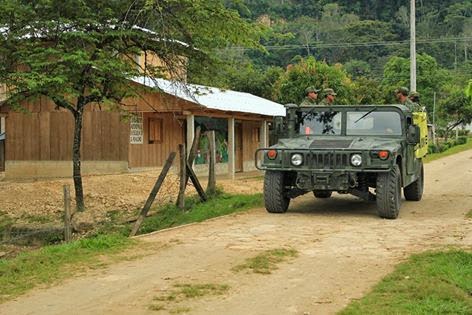 Army truck passes the woman's community center next to Galeano's Zapatista school and health center in La Realidad, Chiapas, Mexico.