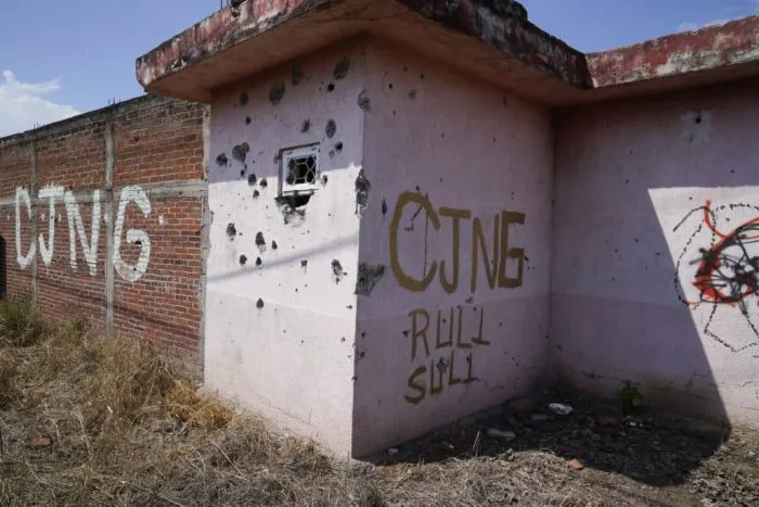 The letters "CJNG" as an abbreviation for the Jalisco Cartel - New Generation scrawled on the facade of an abandoned house in El Limoncito, in the state of Michoacan, Mexico. Photo: AP